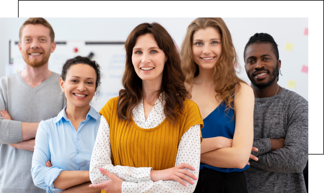 Group of five people smiling in office setting.